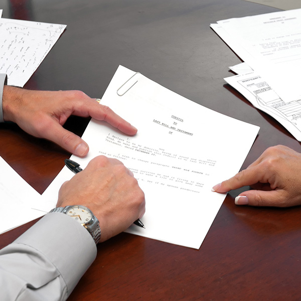 lawyer hands holding a piece of paper and a pen