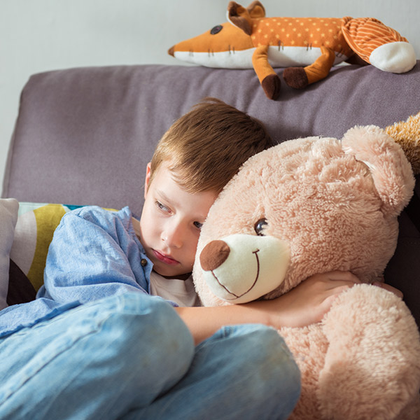 A boy hugging a teddy bear